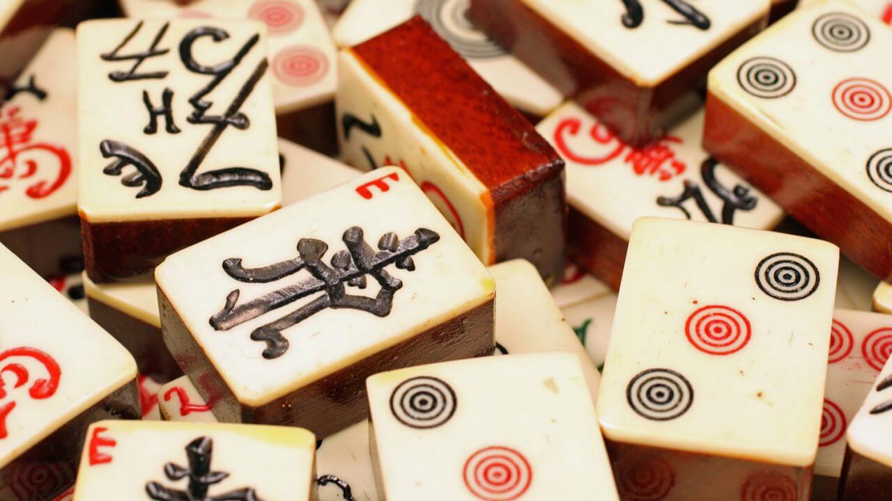 Mahjong tiles are engraved with Chinese characters and numbers